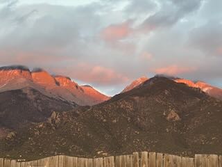 The evening AlpenGlow that lights up the tops of Crestone Peak and the Crestone Needles mountains. They are 14,000+ foot peaks in the Sangre de Cristo Mountain range in Colorado.
